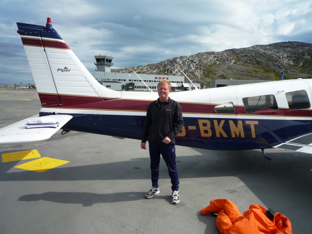 Paul Yates - out of his immersion suit at Nuuk (with my papers which are about to be blown away on the tal)